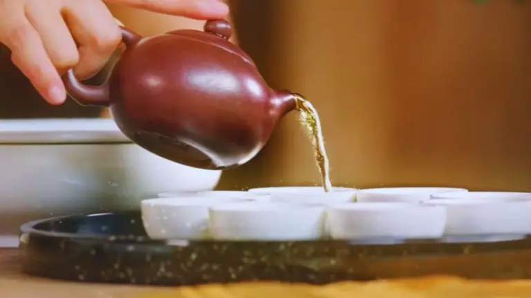 Chinese Tea Tasting 13 Botanical garden tea events — Yixing clay teapots and a gaiwan set for a Gong Fu Cha tea tasting, Oolong tea pouring into teacups from TEA: The Drink That Changed The World
